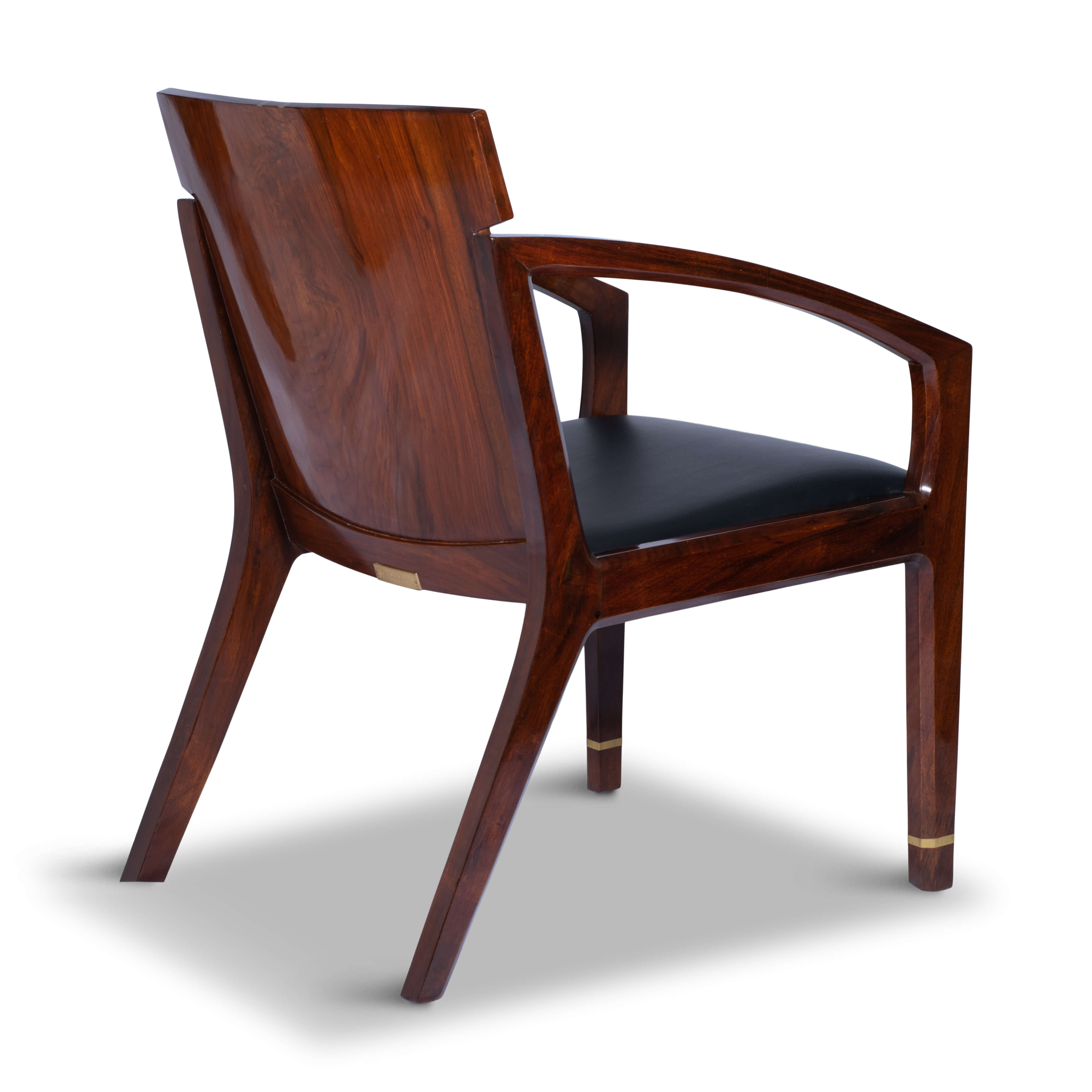 Rear view of the armchair’s slatted rosewood backrest and solid frame on a white backdrop