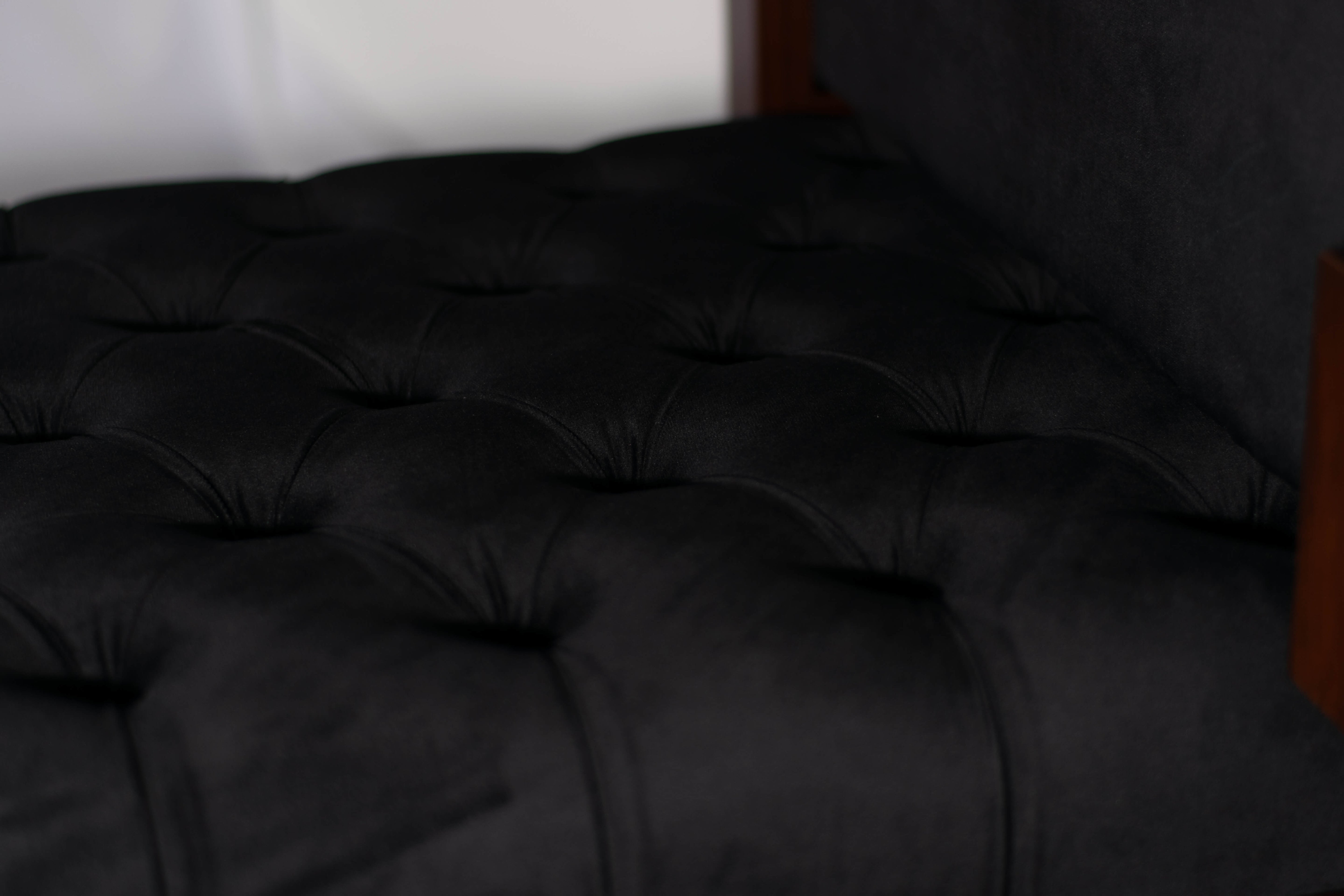 Close-up of the luxurious black velvet upholstery on the CETI rosewood daybed showcasing its plush texture and deep tufting