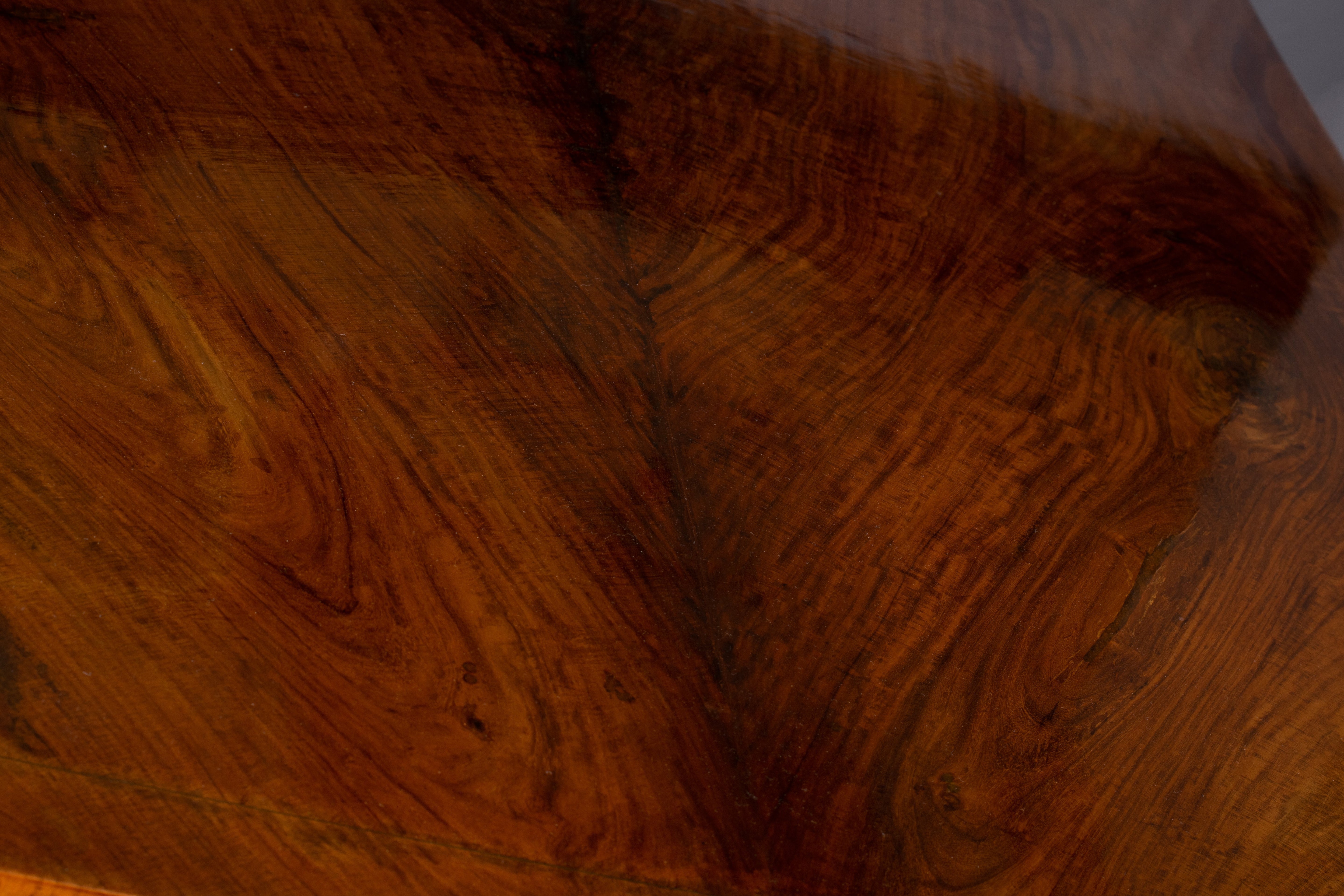 Detail of AVA table edge showing handcrafted joinery and warm, polished wood tone