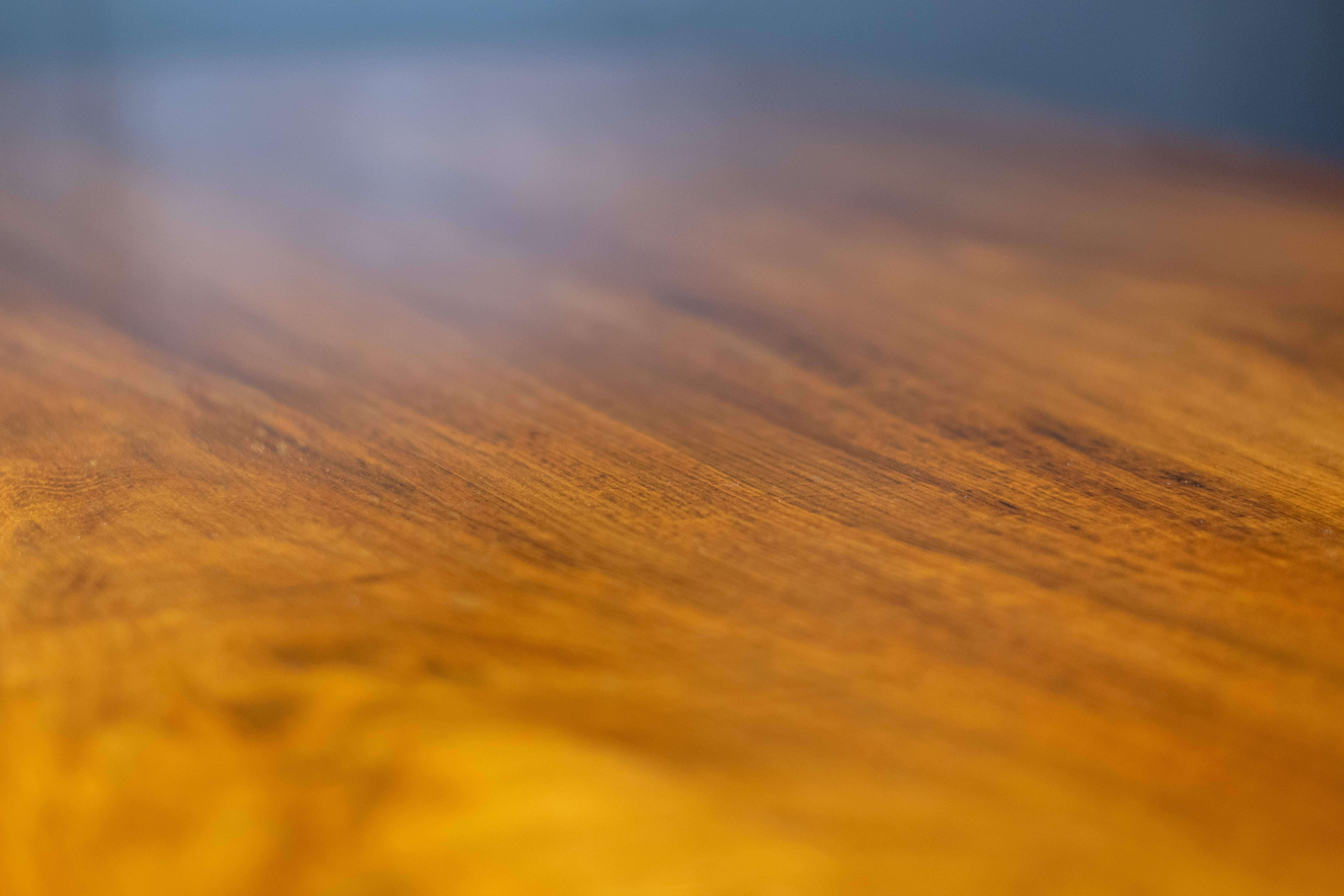 Close-up of the desk’s sculptural wooden top and rich rosewood grain