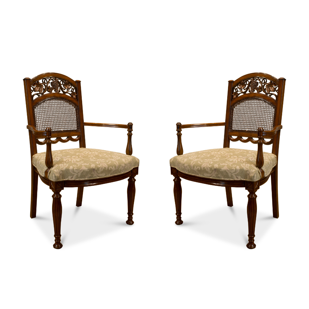 Pair of hand-carved rosewood armchairs with woven cane backs on white background