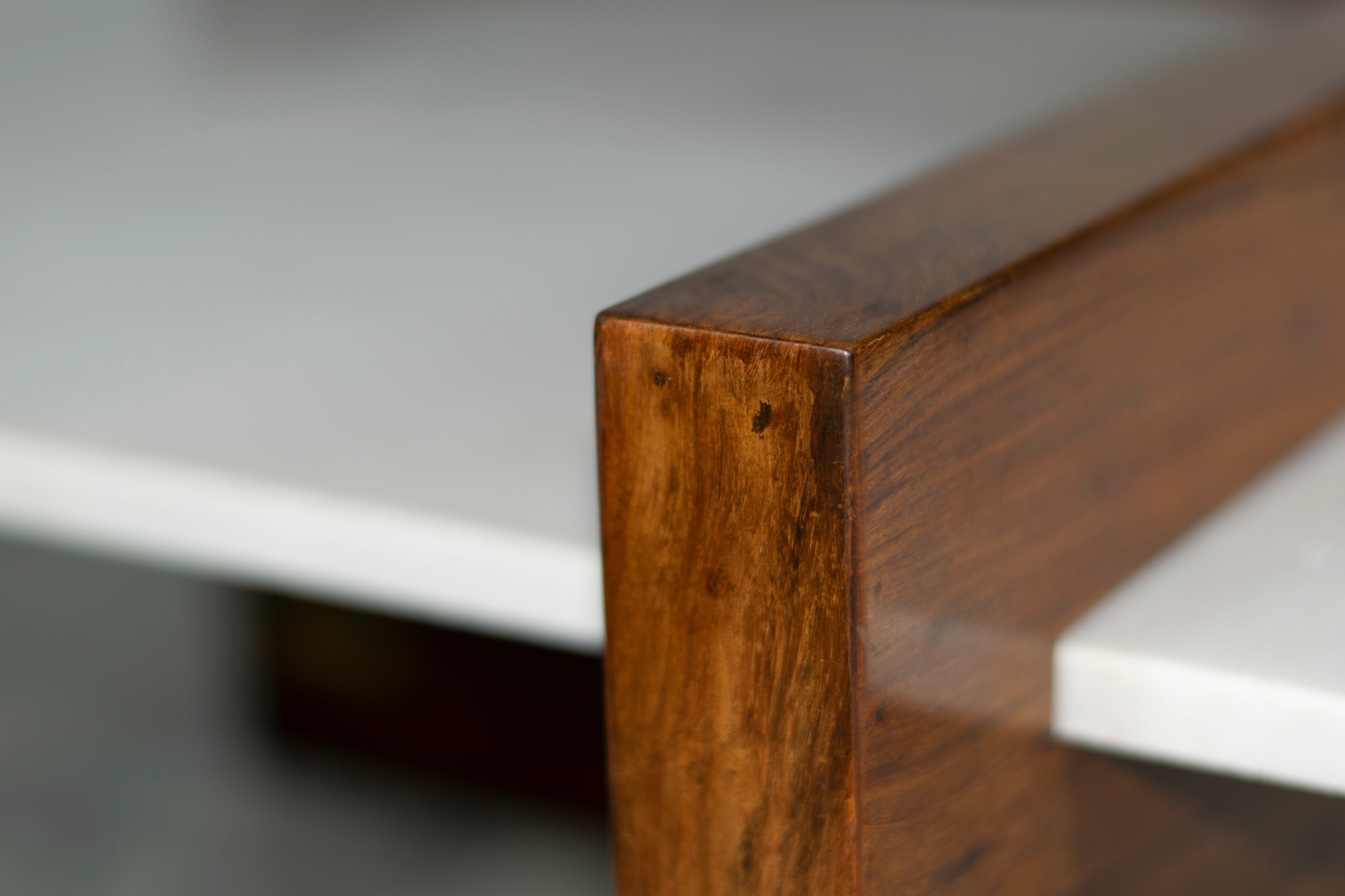Close-up of rich rosewood grain in contrast to marble