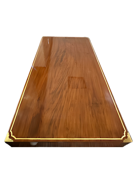 Aerial shot of the desk top showing rich rosewood grains and brass inlay border