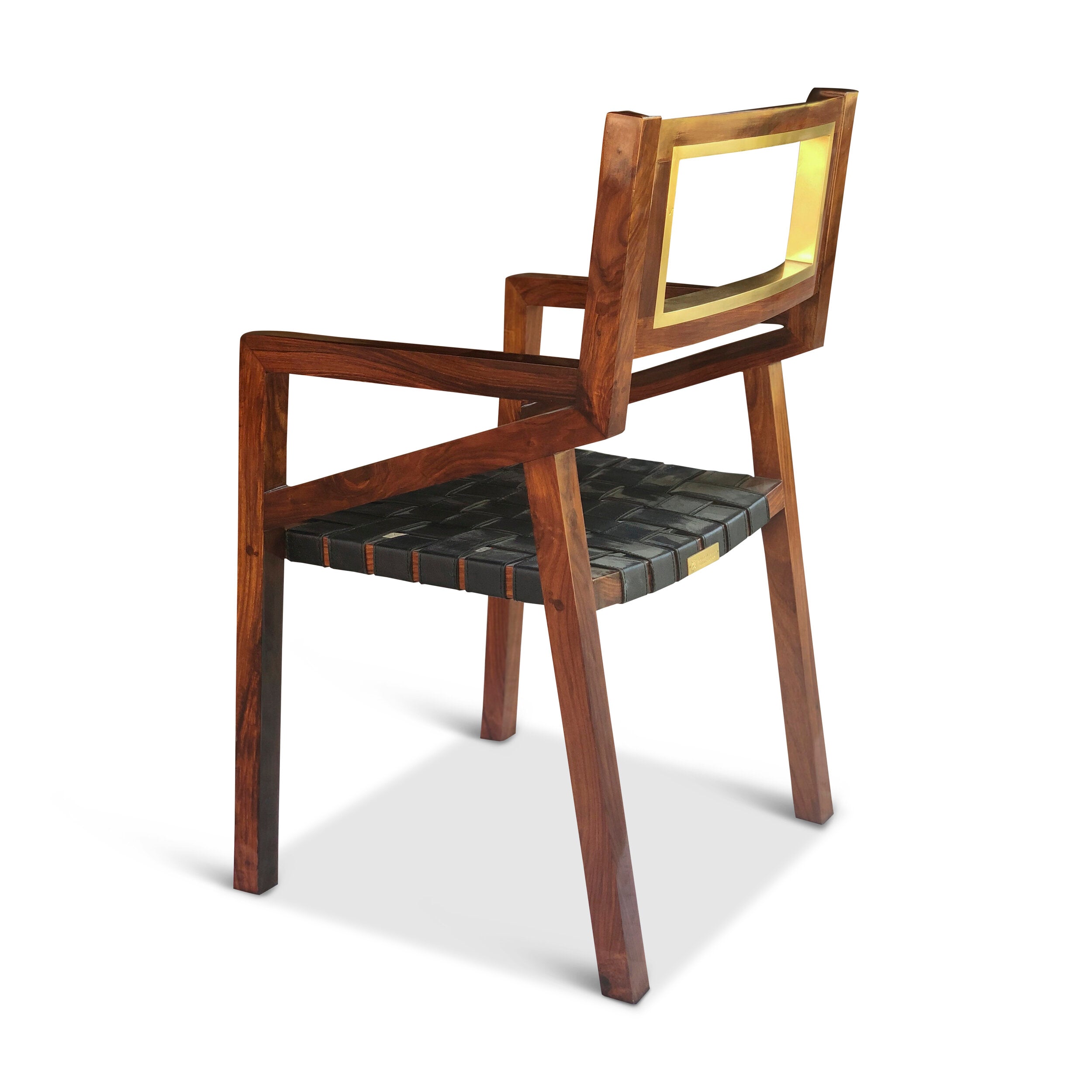 Angled shot of the wooden dining chair showcasing its minimalist silhouette and contoured seat