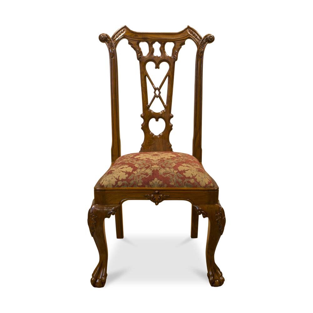 Hand-carved rosewood chair with ornate back and upholstered seat on white backdrop