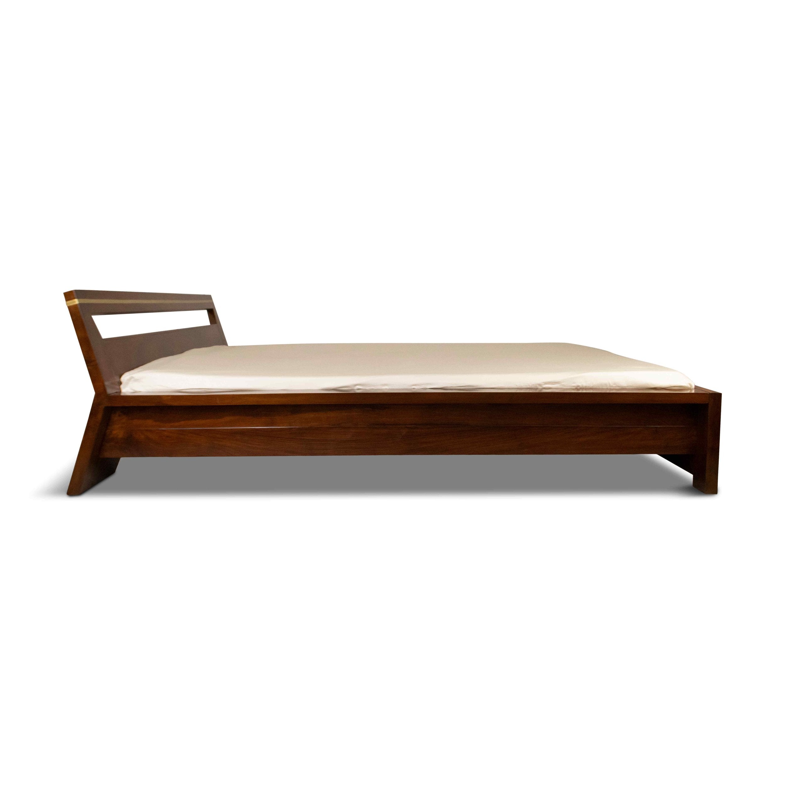 Handcrafted rosewood platform bed frame with slanted headboard on white background