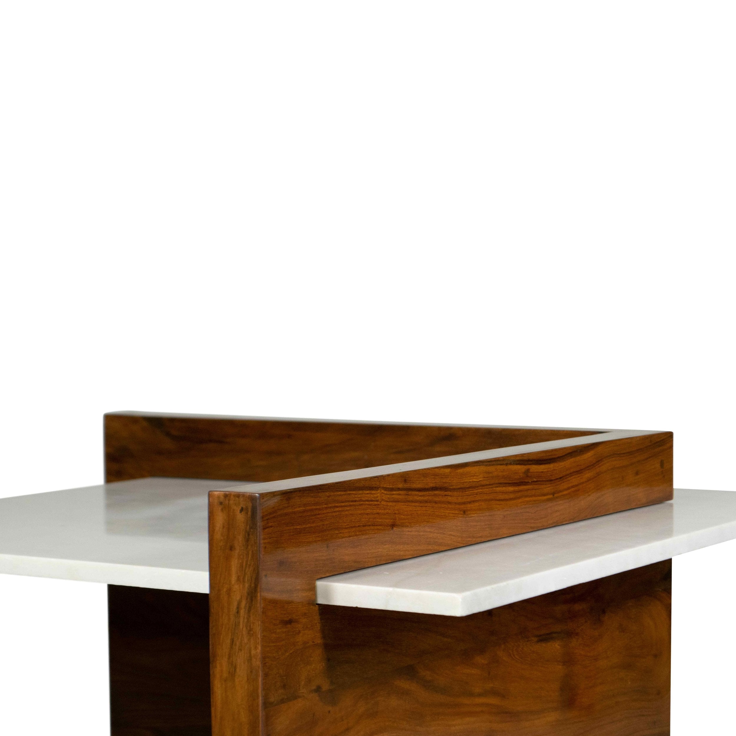 Angled perspective of MIRA’s solid wood coffee table showcasing its curved base and marble inset